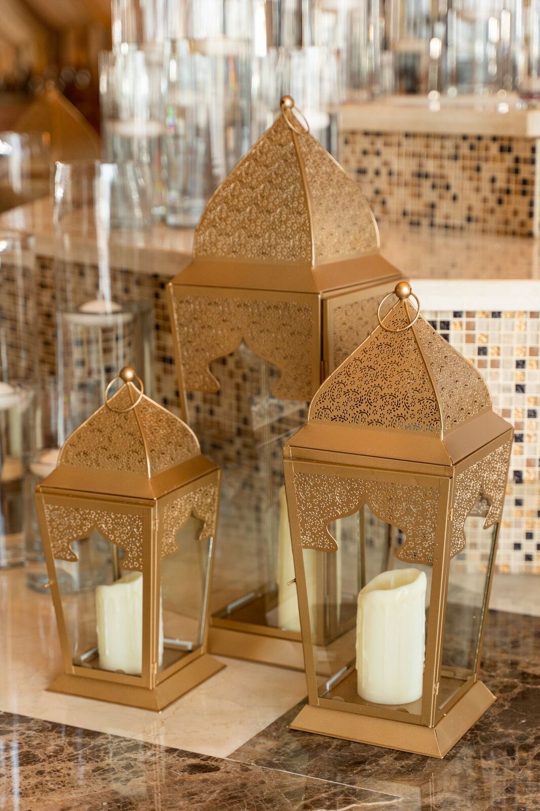 Chic rose gold lanterns with a modern metallic finish, featuring delicate cut-out patterns that cast beautiful light patterns. The lanterns add a touch of warmth and elegance, perfect for enhancing the ambiance of any space with a contemporary flair.