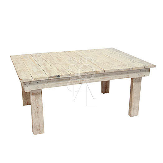 Rustic coffee table made of wood with a distressed finish, showcasing a charming, aged look with sturdy legs and a spacious top.