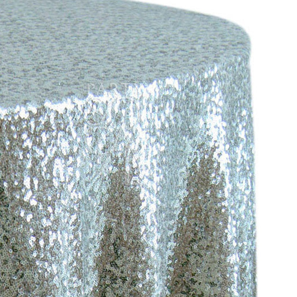 Round sequin tablecloth in sparkling silver, showcasing a bright and reflective surface. The silver sequins bring a glamorous and festive touch, ideal for enhancing any celebratory or formal event.