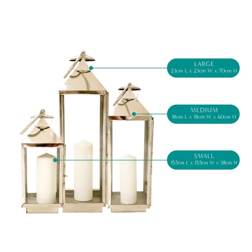 Elegant silver lanterns with a sleek, metallic finish and intricate detailing. The lanterns feature a classic design that adds a touch of sophistication and charm, perfect for illuminating and enhancing any indoor or outdoor setting.