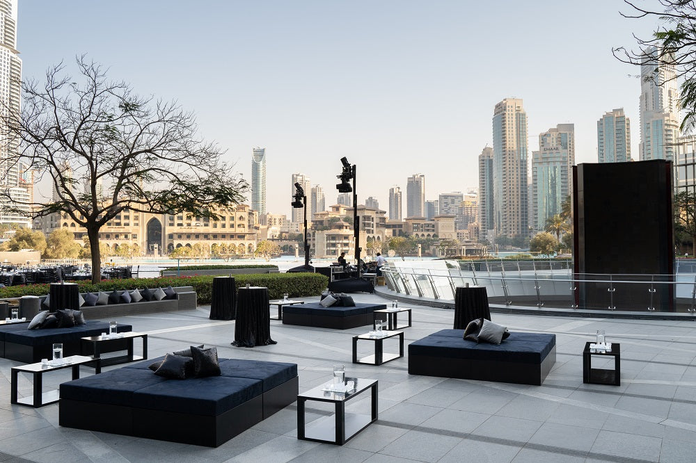 Modern dark grey sofa island with a sleek design, offering a spacious and comfortable seating option, perfect for contemporary living spaces or outdoor lounges.
