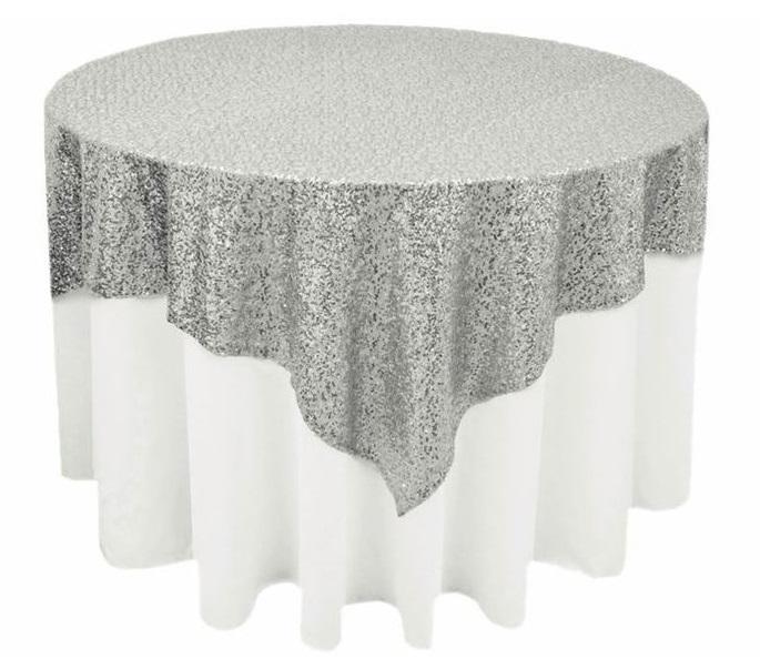 Elegant sequin overlay in a sparkling silver color, featuring a shimmering, reflective surface. The silver sequins create a dazzling effect, perfect for adding a touch of modern glamour and sophistication to table settings, event decor, or special occasions.