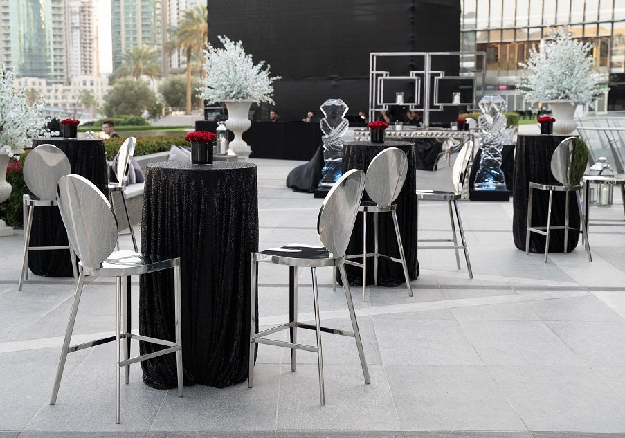 Round cocktail tables, offering a compact and stylish design perfect for standing receptions and casual gatherings, ideal for socializing and drink service.