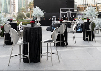 Round cocktail tables, offering a compact and stylish design perfect for standing receptions and casual gatherings, ideal for socializing and drink service.