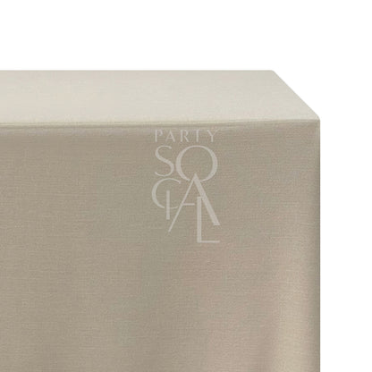 A rectangular linen blend tablecloth in bleached sand, with a soft, neutral tone. This refined tablecloth adds subtle warmth and elegance to your dining area, perfect for casual gatherings and special occasions.