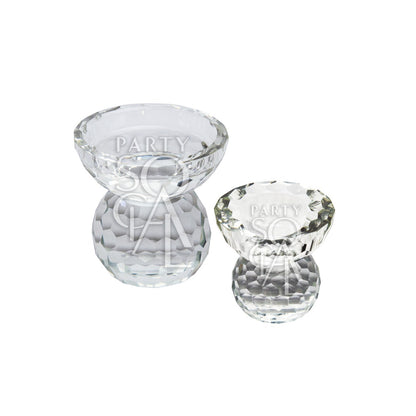 A crystal glass candle holder, featuring a sophisticated design with clear, faceted glass that reflects light beautifully. The elegant crystal material adds a touch of luxury and refinement, making it ideal for enhancing the ambiance of any space. Perfect for use on tables, mantels, or for special occasions.