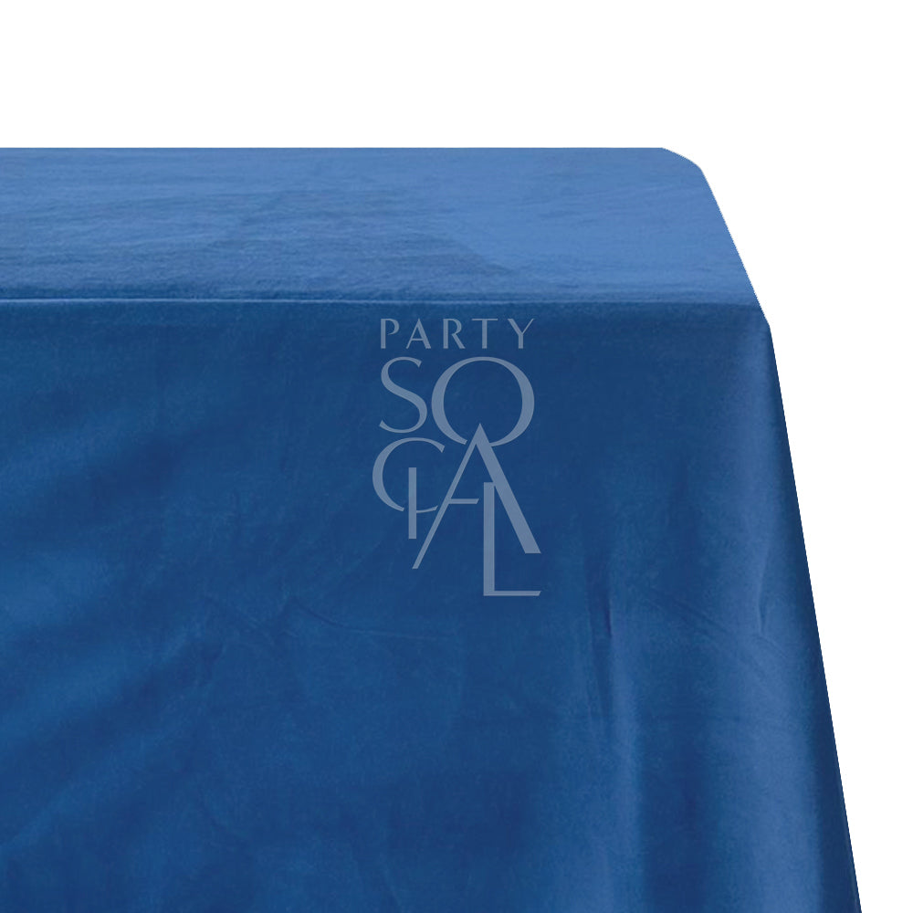 A rectangular velvet tablecloth in deep blue, made from a cotton/linen blend. This striking tablecloth adds a sophisticated and bold touch to your dining area, with its plush fabric and rich, vibrant color.