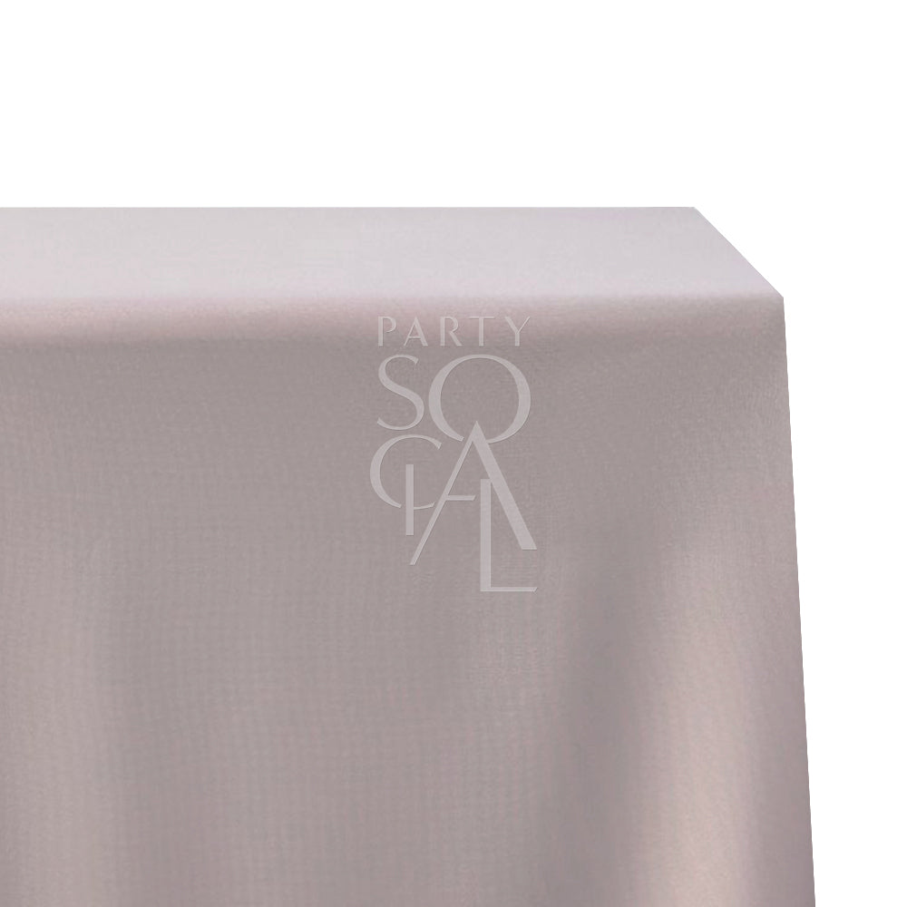 A rectangular cotton-linen tablecloth in soft dusty pink, with a gentle and elegant hue. This charming tablecloth adds a touch of warmth and sophistication to your dining setting, ideal for both formal occasions and casual meals.