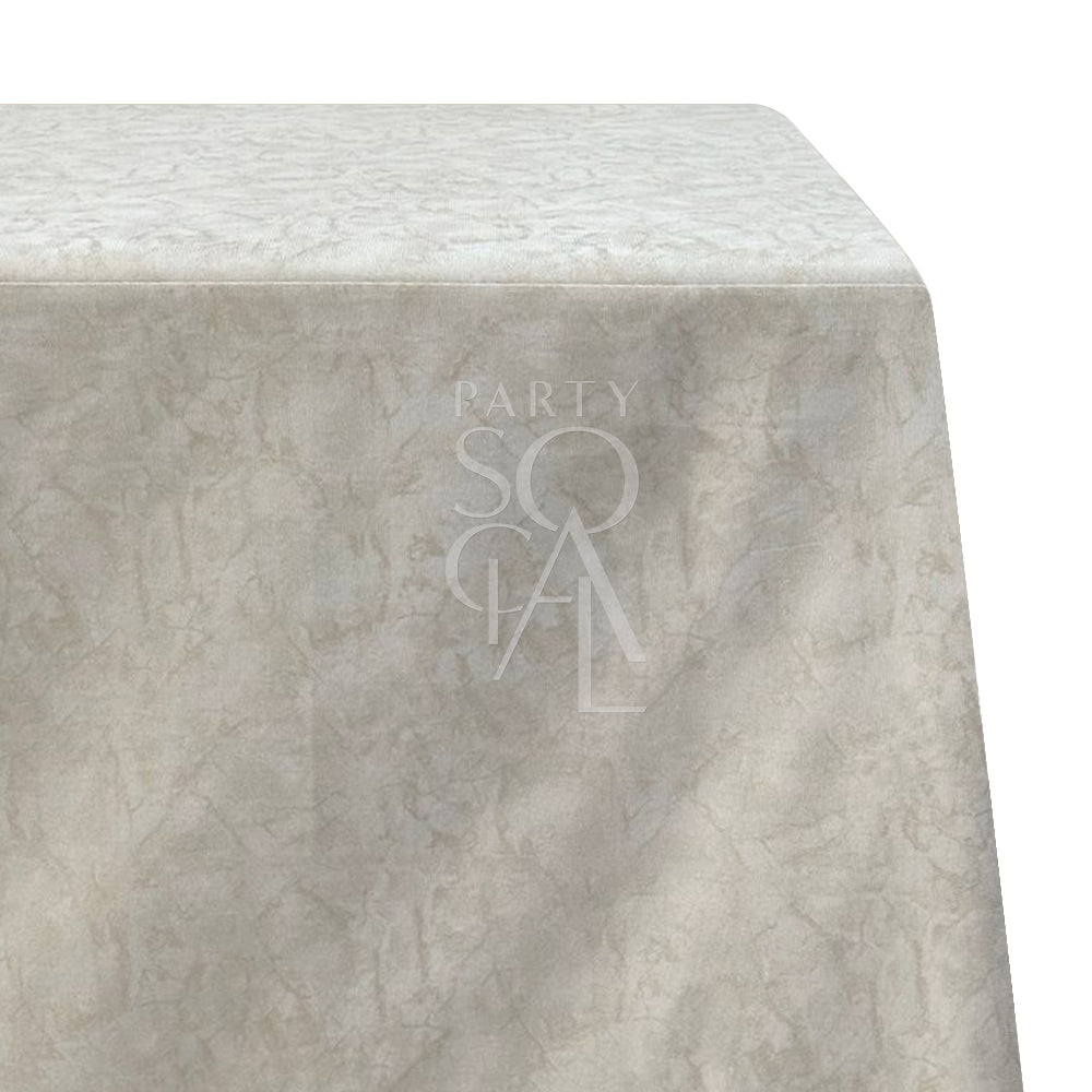 A gold foil rectangular tablecloth with a white linen base. This elegant tablecloth features shimmering gold foil accents that create a sophisticated and luxurious look. Ideal for adding a touch of glamour to your dining setting, it is perfect for special occasions and formal events with its high-quality linen fabric.