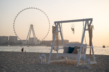 Charming white wooden swing with a classic design, featuring a smooth, polished finish and sturdy rope attachments. The swing’s clean white color and simple style add a touch of elegance and nostalgia, making it an inviting addition to gardens, patios, or outdoor spaces.