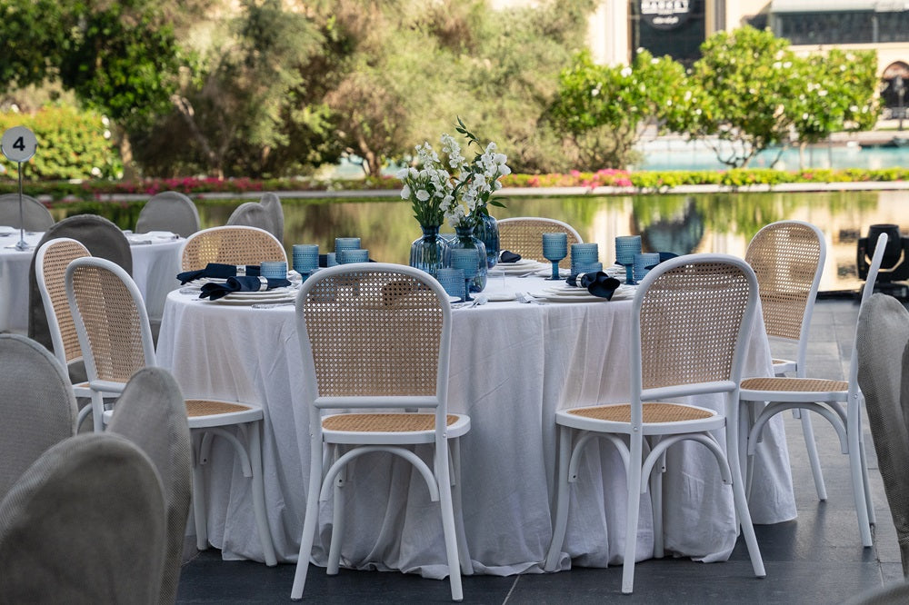 A cylindrical glass vase in vibrant blue, featuring a sleek and elegant design. The blue glass adds a pop of color and a touch of sophistication, making it a stylish centerpiece for floral arrangements or decorative accents in any space.