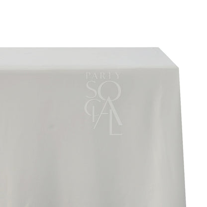 A rectangular cotton-linen tablecloth in off white, featuring a soft and creamy shade. This refined tablecloth enhances your dining setting with a touch of understated elegance, perfect for both special events and daily use.