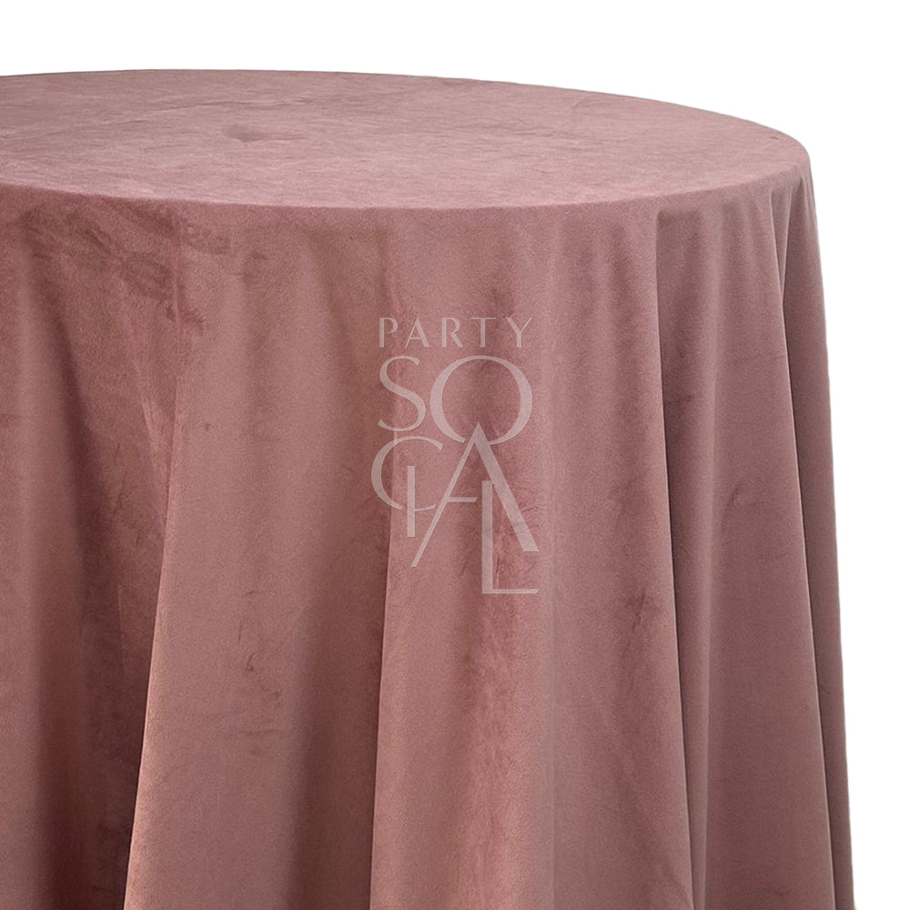 A round velvet tablecloth in old rose, with a soft and vintage-inspired hue. This charming tablecloth adds a touch of classic elegance and warmth to your dining area, perfect for enhancing both formal and informal gatherings.