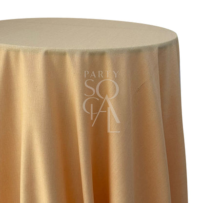 Round linen blend tablecloth in peach, offering a soft and warm hue. The peach color provides a gentle and charming touch, ideal for a romantic and inviting table setting.