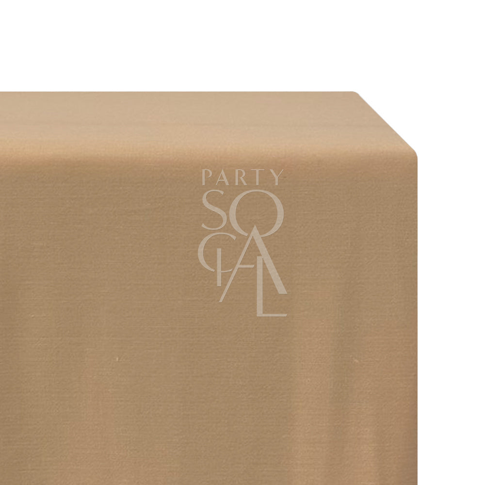 A rectangular linen blend tablecloth in soft peach, with a delicate and warm hue. This charming tablecloth adds a touch of elegance and freshness to your dining area, perfect for both casual meals and special occasions.