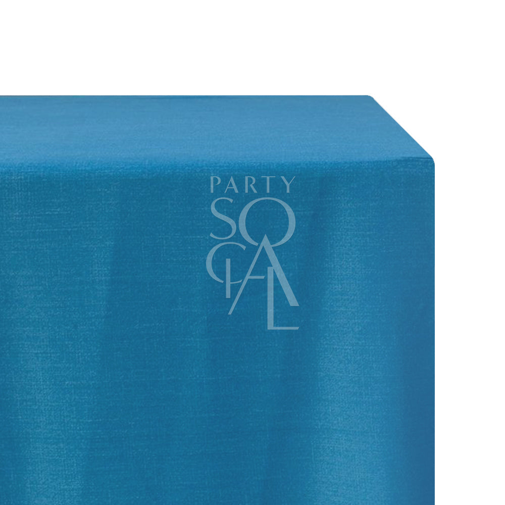 A rectangular linen blend tablecloth in vibrant peacock blue, with a striking and bold hue. This eye-catching tablecloth adds a touch of elegance and drama to your dining area, perfect for upscale events and special occasions.