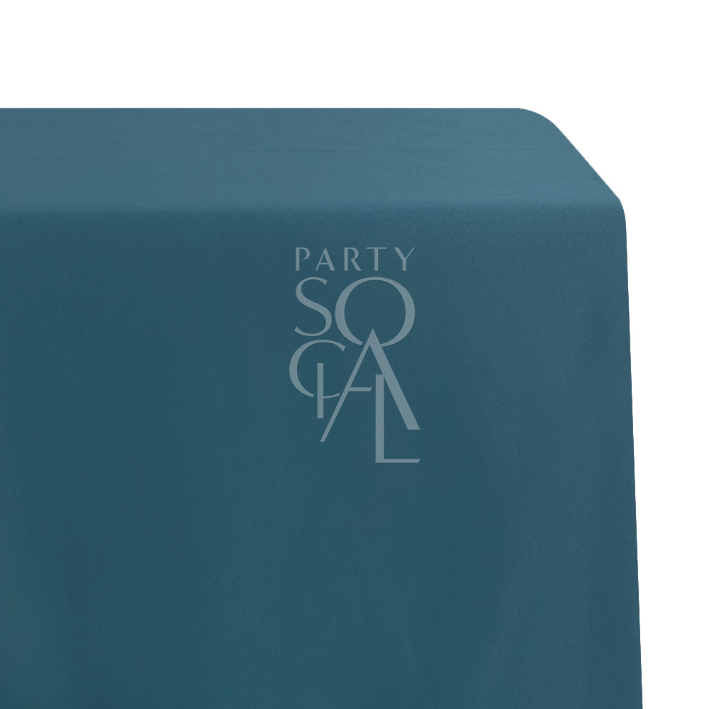 A rectangular satin tablecloth in rich royal green, with a smooth and opulent finish. This luxurious tablecloth enhances your dining area with its bold and elegant color, perfect for upscale events and special occasions.