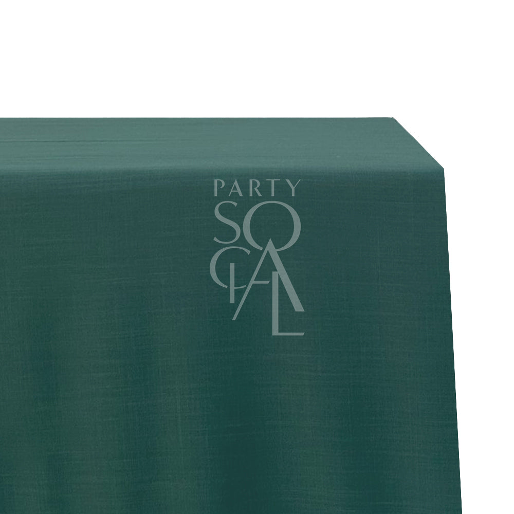 A rectangular cotton-linen tablecloth in royal green, with a rich and luxurious hue. This elegant tablecloth enhances your dining area with a touch of grandeur and sophistication, ideal for formal occasions and upscale settings.