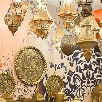 A cone-shaped Moroccan hanging pendant in rose gold, featuring intricate and detailed metalwork. The rose gold finish adds a touch of luxury and warmth, while the cone shape and elaborate patterns create an exotic and sophisticated ambiance, perfect for enhancing the decor of any room.