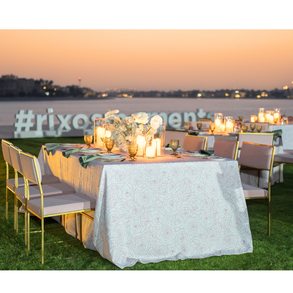 A pink floral rectangular tablecloth made from a polyester-linen blend. This vibrant tablecloth features a charming floral pattern in shades of pink, adding a touch of elegance and freshness to your dining area. Ideal for both casual meals and special occasions, it combines style and durability with its high-quality fabric.