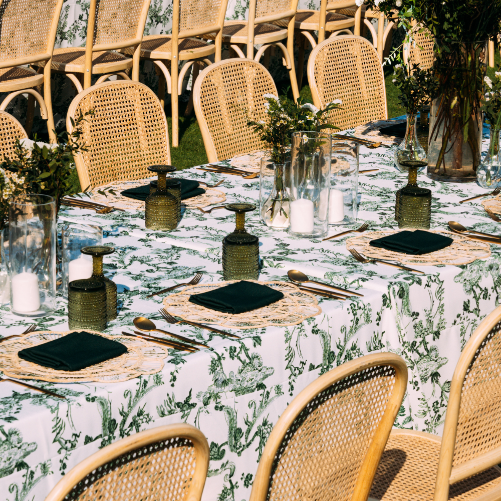 A rectangular linen tablecloth with a green vine pattern, featuring an elegant and nature-inspired design. This tablecloth adds a touch of freshness and sophistication to your dining area, with its intricate green vine motif enhancing both casual and formal settings.