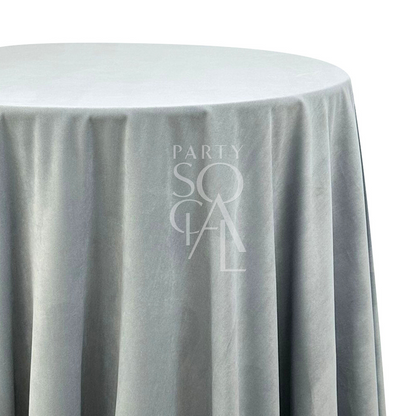 A round velvet tablecloth in steel blue, featuring a sleek and modern shade. This elegant tablecloth enhances your dining area with its contemporary and plush texture, ideal for both sophisticated and casual occasions.