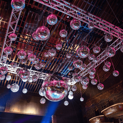 Disco Balls, available for rent, featuring a classic mirrored design that adds a sparkling, retro touch to any event. These eye-catching decorations are perfect for creating a lively and festive atmosphere at parties, weddings, and other celebrations. The shimmering surfaces reflect light beautifully, enhancing your event with a dynamic and glamorous effect. Ideal for dance floors and themed parties, these Disco Balls bring a fun and vibrant element to your decor.