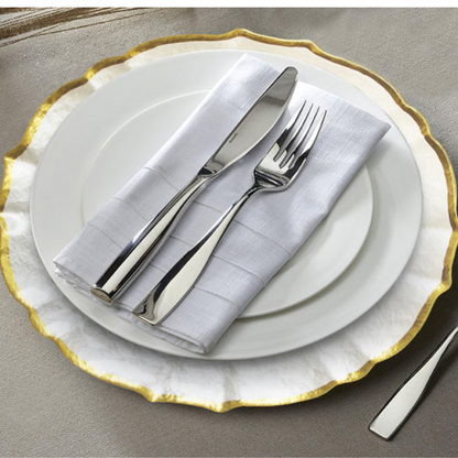 A clear pearl charger plate with a gold rim featuring an elegant and sophisticated design. This charger plate has a transparent pearl finish complemented by a luxurious gold rim, adding a touch of glamour to any table setting. Ideal for formal dining occasions or special events, it enhances the overall presentation of your tableware.