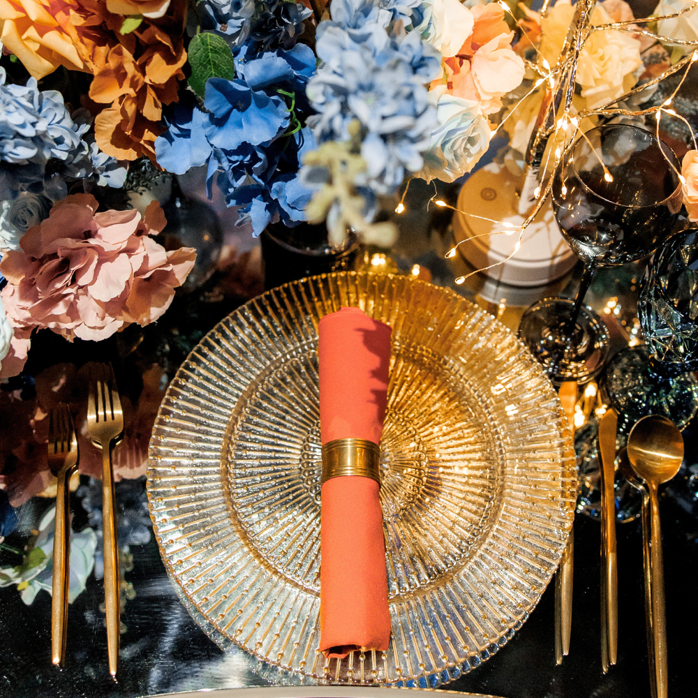 A clear charger plate featuring a stunning radial pattern with gold accents. Perfect for adding a sophisticated and stylish touch to your dining table.