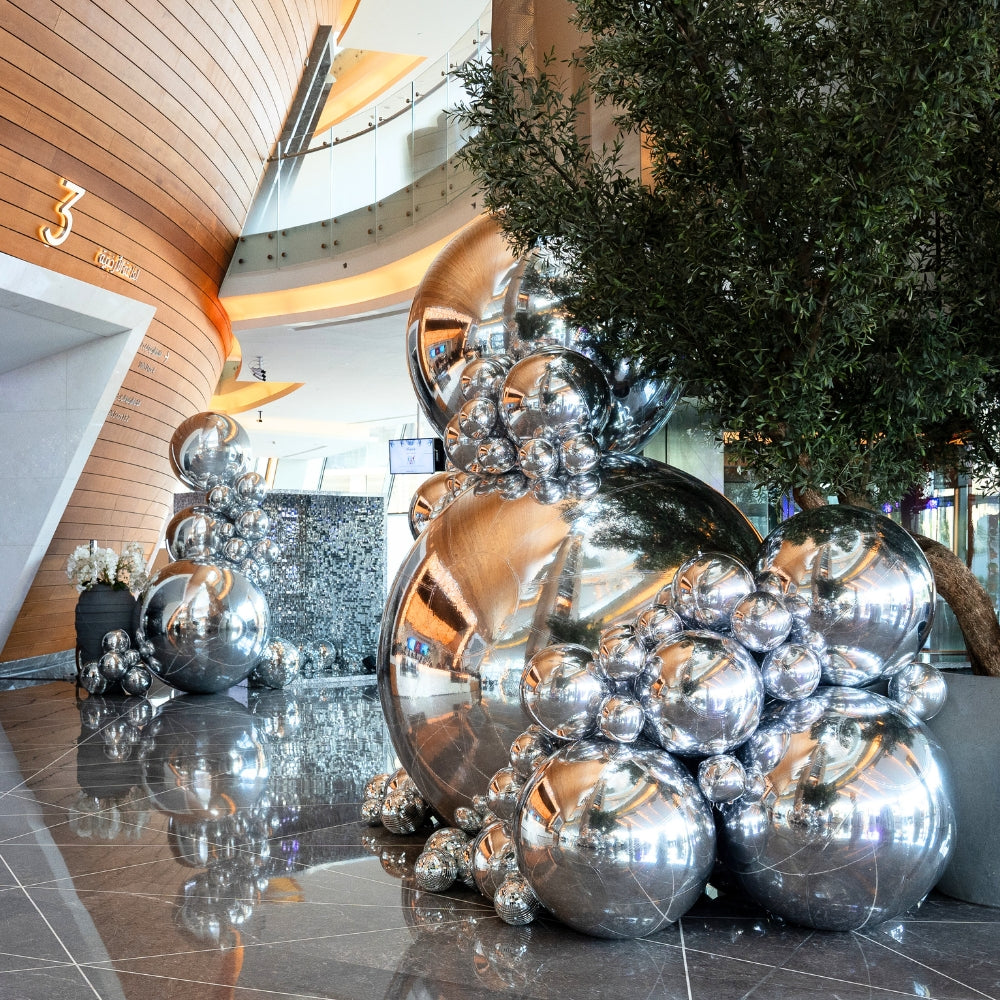 Silver Mirror Inflatable Balls featuring a reflective, mirrored surface that adds a touch of sparkle and glamour to any event. These eye-catching inflatable balls are perfect for creating a lively and festive atmosphere at parties, weddings, and special occasions. Their shimmering finish reflects light beautifully, enhancing your decor with a dynamic and stylish effect.