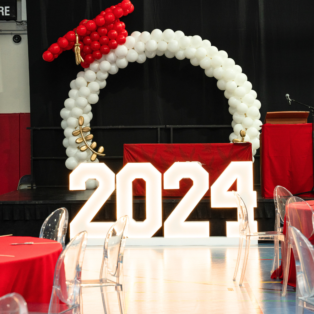 An LED stand displaying &quot;2024&quot; in white and red, featuring a bright and modern design. This eye-catching indoor stand is perfect for celebrating the new year, adding a festive and vibrant touch to events, parties, and home decor.