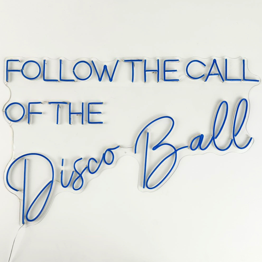 A &quot;Follow the Call of The Disco Ball&quot; LED neon sign in multicolor and blue, featuring a vibrant and dynamic design. This colorful sign is suitable for indoor use, adding a lively and retro touch to parties, events, or home decor with its playful and energetic ambiance.