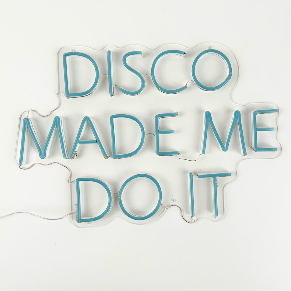 A &quot;Disco Made Me Do It&quot; LED neon sign in blue, featuring a bright and eye-catching design. This vibrant sign is suitable for indoor use, adding a fun and playful touch to parties, events, or home decor with its lively and retro style.