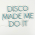 A "Disco Made Me Do It" LED neon sign in blue, featuring a bright and eye-catching design. This vibrant sign is suitable for indoor use, adding a fun and playful touch to parties, events, or home decor with its lively and retro style.