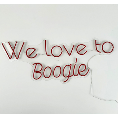 A &quot;We Love To Boogie&quot; LED neon sign in red, featuring a bold and vibrant design. This eye-catching sign is suitable for indoor use, adding a fun and energetic touch to parties, events, or home decor with its lively and nostalgic vibe.