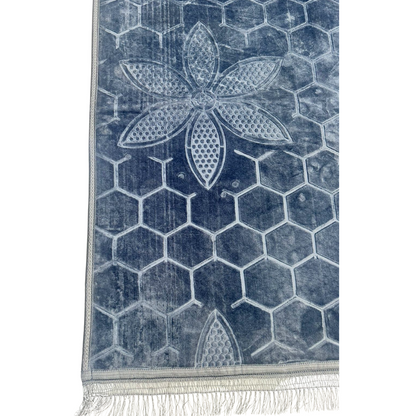 A blue rug with a self-print pattern, featuring a subtle and stylish design. The rich blue color and textured print add depth and elegance to any room, making it a sophisticated addition to both modern and classic decor.