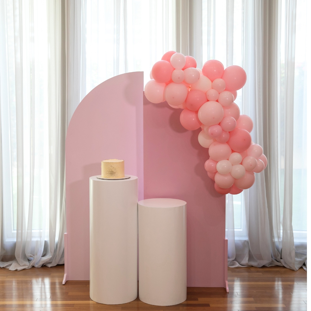 A backdrop in soft pink, featuring an elegant and refined design. This charming pink backdrop adds a touch of sophistication and warmth to any setting, making it perfect for enhancing the ambiance of events, celebrations, and special occasions with its delicate and stylish appearance.