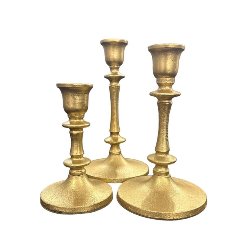 A set of three antique brass candle holders featuring a vintage-inspired design with an elegant, aged finish. These candle holders add a classic and sophisticated touch to any decor, enhancing the ambiance with their timeless charm. Ideal for formal events, dinners, or creating a warm, inviting atmosphere at home.