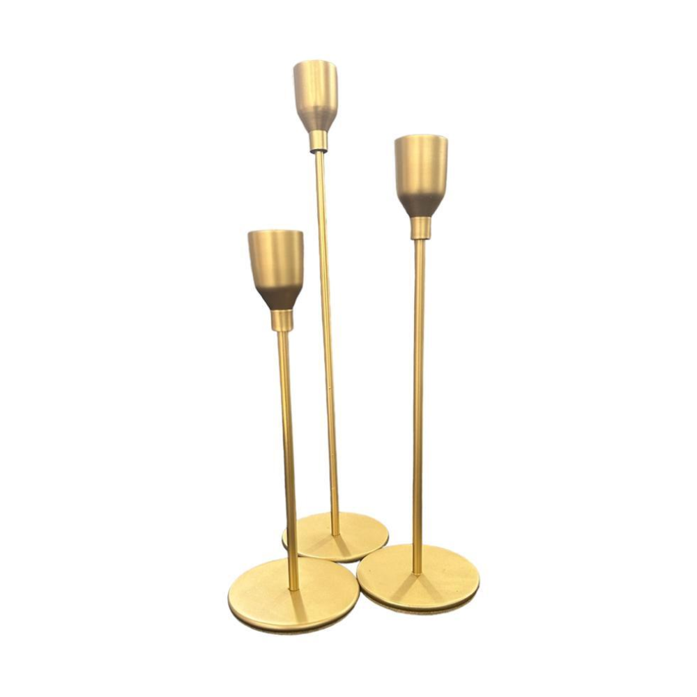 A set of three gold slim candle holders featuring a sleek and elegant design. These candle holders add a touch of sophistication and glamour to any table setting or decor. Their slender, gold finish creates a stylish and refined look, perfect for enhancing the ambiance of formal events, dinners, or special occasions.