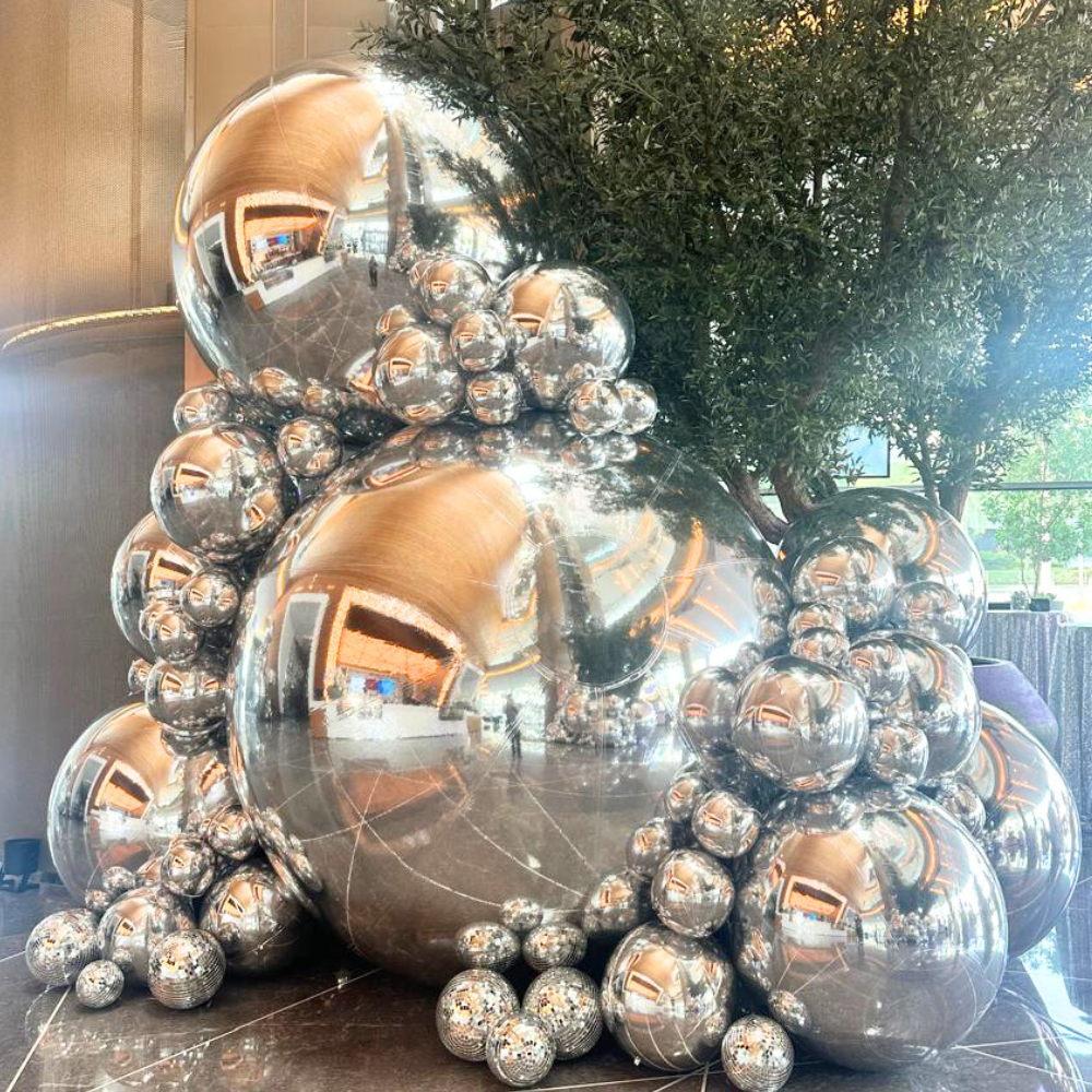 Silver Mirror Inflatable Balls featuring a reflective, mirrored surface that adds a touch of sparkle and glamour to any event. These eye-catching inflatable balls are perfect for creating a lively and festive atmosphere at parties, weddings, and special occasions. Their shimmering finish reflects light beautifully, enhancing your decor with a dynamic and stylish effect.