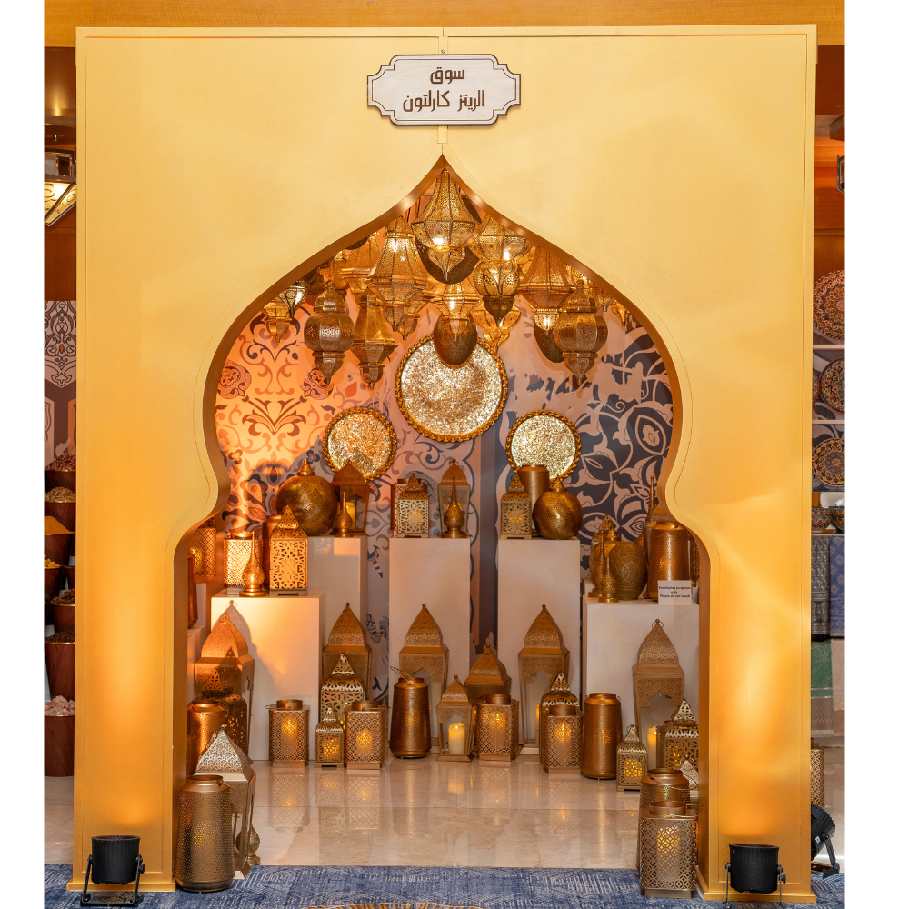 A beautifully designed Arabic-style arch featuring ornate patterns and glowing LED lights, offered for rent. The arch is lit with a warm, inviting glow, highlighting its intricate details and elegant curves.