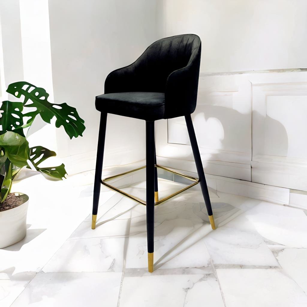 A chic velvet stool in black. This sleek stool is upholstered in soft, luxurious black velvet, offering a sophisticated and modern touch to any room. Its versatile black color makes it a stylish addition to various decor styles, whether used as extra seating or a decorative piece.