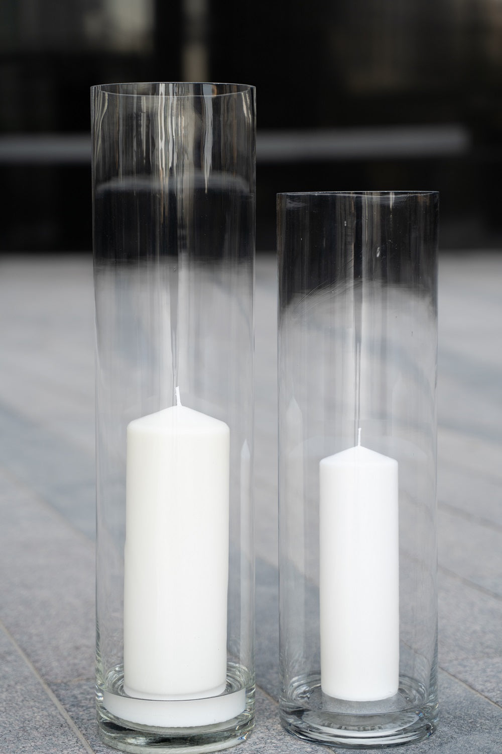 Tall and elegant floor cylinder glass vases with a sleek, transparent design. These vases feature a smooth, cylindrical shape, perfect for displaying long-stemmed flowers or as standalone decorative pieces. Their minimalist and versatile style adds a touch of modern sophistication to any room or event decor.
