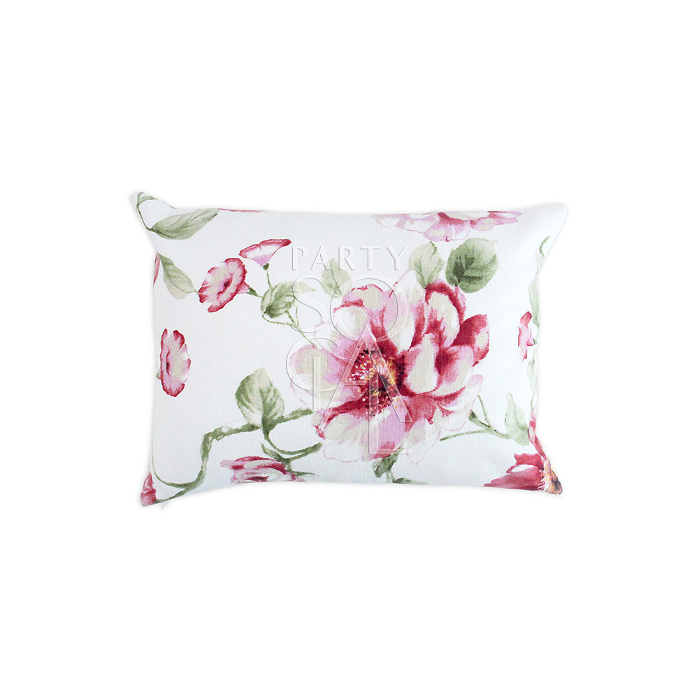 White cushion featuring large pink floral prints.